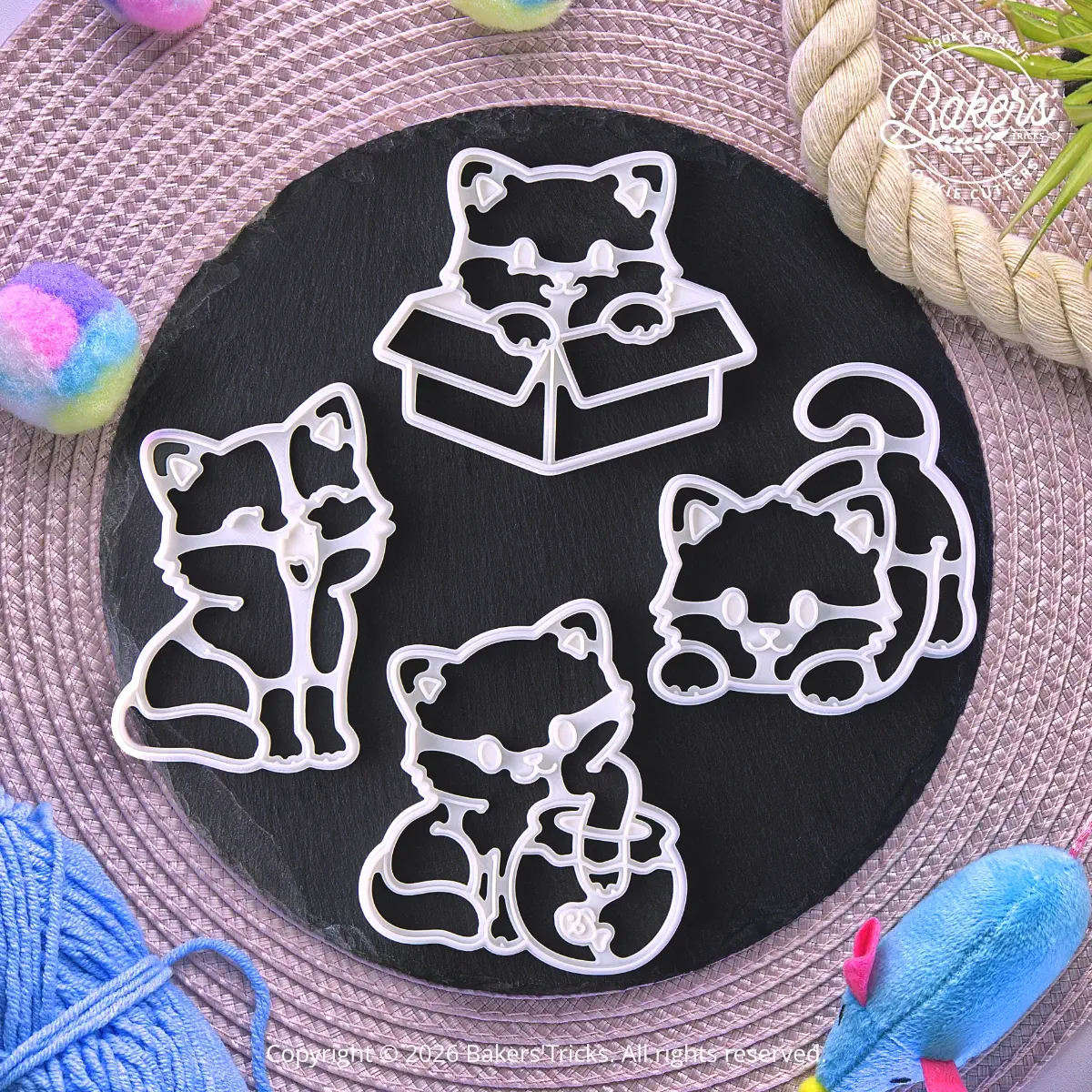 Set of 4 Bakers’Tricks® cat cookie cutters featuring a cat in a box, a mischievous cat, a yawning cat, and a cat with a fishbowl.
