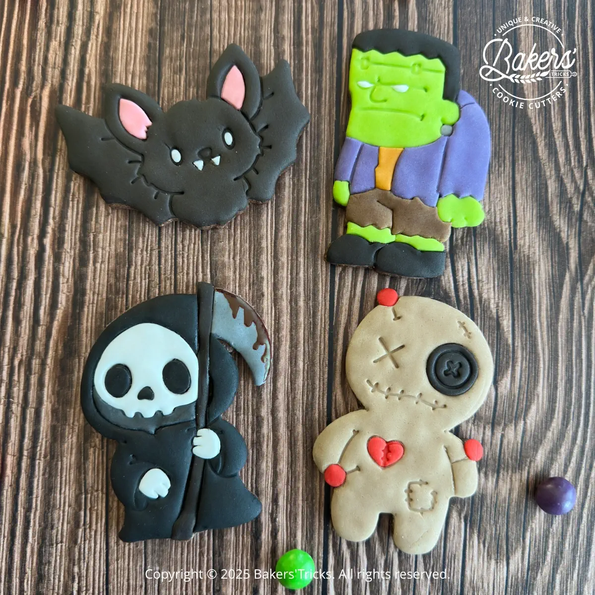 Halloween cookies decorated with fondant featuring a bat, Frankenstein's monster, the Grim Reaper and a voodoo doll.