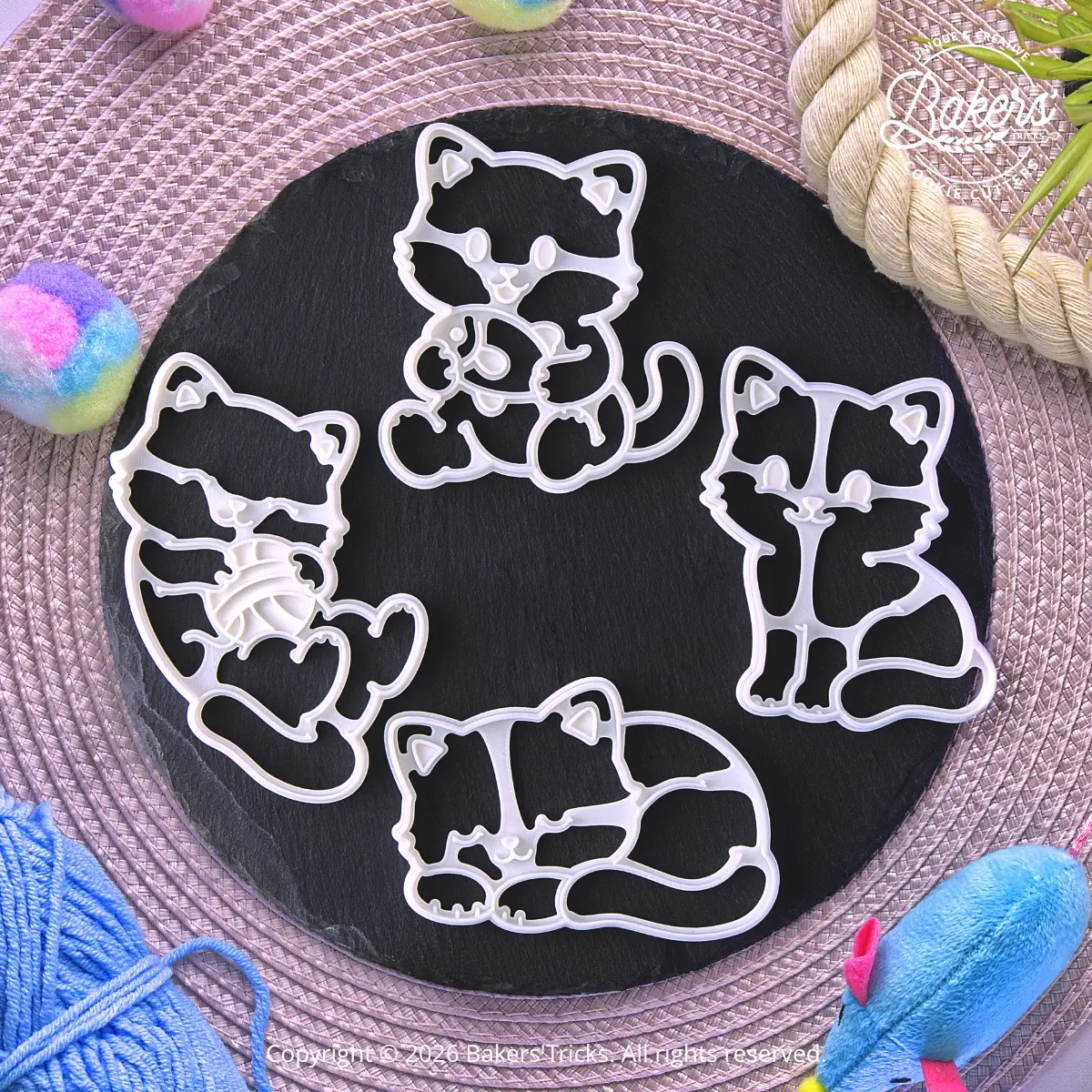 Set of 4 Bakers'Tricks® cat cookie cutters featuring a sitting cat, sleeping cat, cat with fish and cat with a ball of yarn.